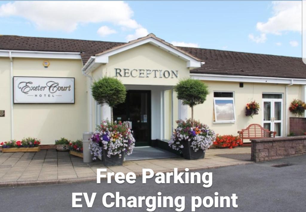 a building with a sign that reads emergency parking ev charging point at Exeter Court Hotel in Exeter