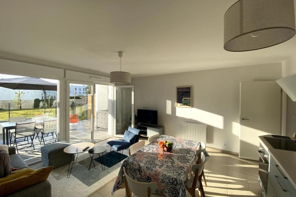 sala de estar con mesa y algunas sillas en Residence 350 meters from the main beach chez lena, en Quiberon