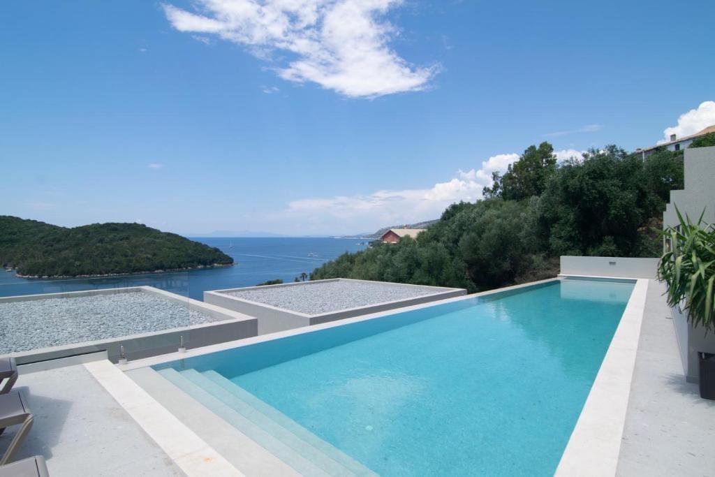 a swimming pool with a view of the ocean at Sivota Deamaris Luxury Boutique Hotel in Syvota