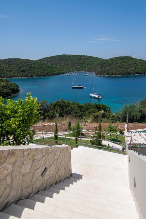 a view of a bay with boats in the water at Sivota Deamaris Luxury Boutique Hotel in Syvota