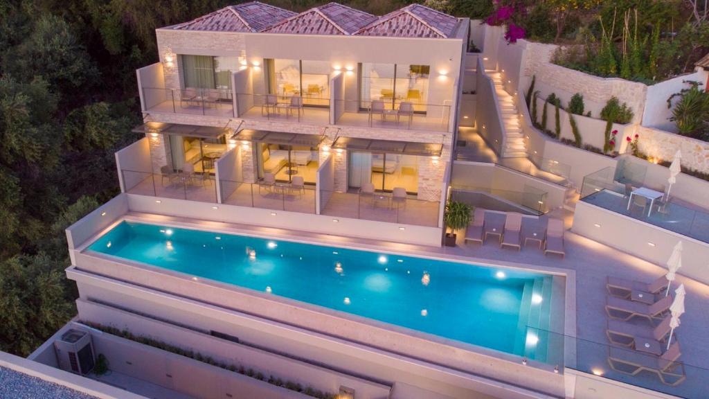 an aerial view of a house with a swimming pool at Sivota Deamaris Luxury Boutique Hotel in Syvota