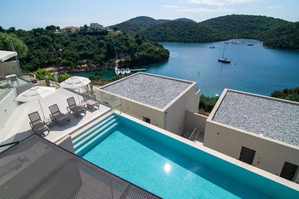 a house with a swimming pool and a view of a river at Sivota Deamaris Luxury Boutique Hotel in Syvota