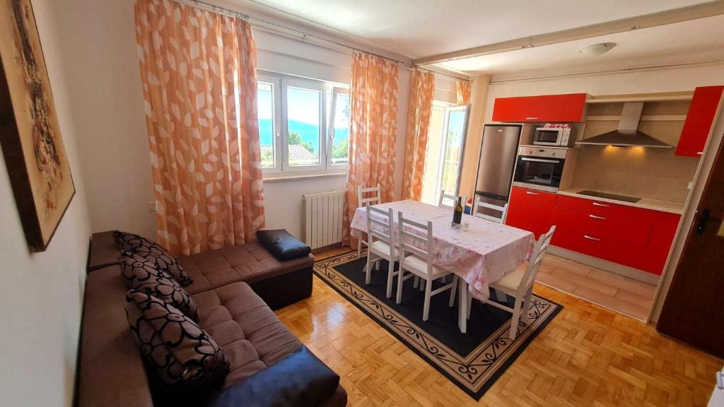 a living room with a table and a couch at Apartmens Adriana in Novi Vinodolski