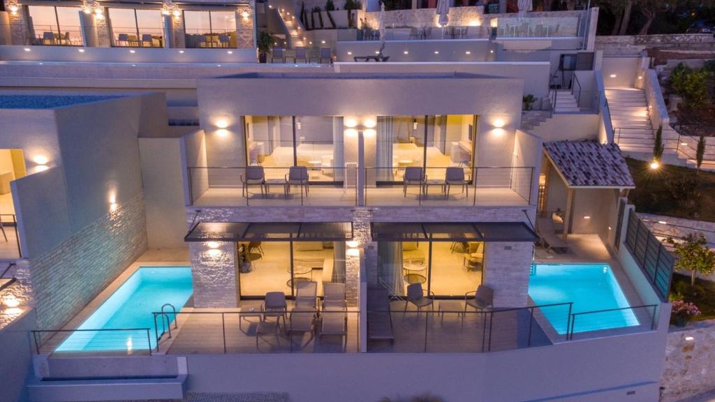 an aerial view of a house at night with a swimming pool at Sivota Deamaris Luxury Boutique Hotel in Syvota