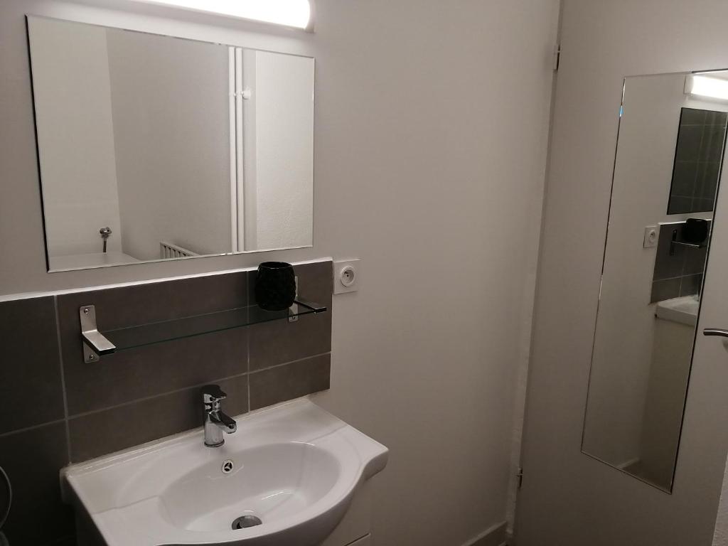 a bathroom with a white sink and a mirror at L'ESCALE DETENTE EN VERCORS in Saint-Jean-en-Royans