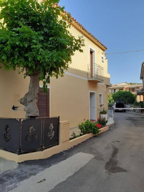 a building with a tree on the side of it at La casetta di Lu Casteddu in San Teodoro