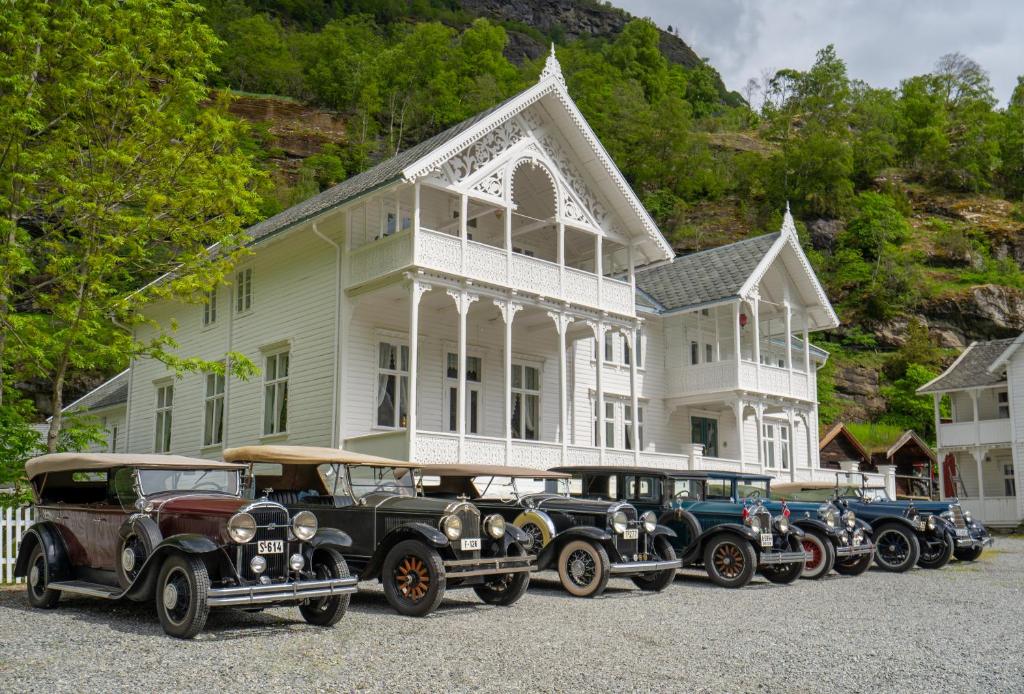 grupa starych samochodów zaparkowanych przed domem w obiekcie Husum Hotel w mieście Borgund