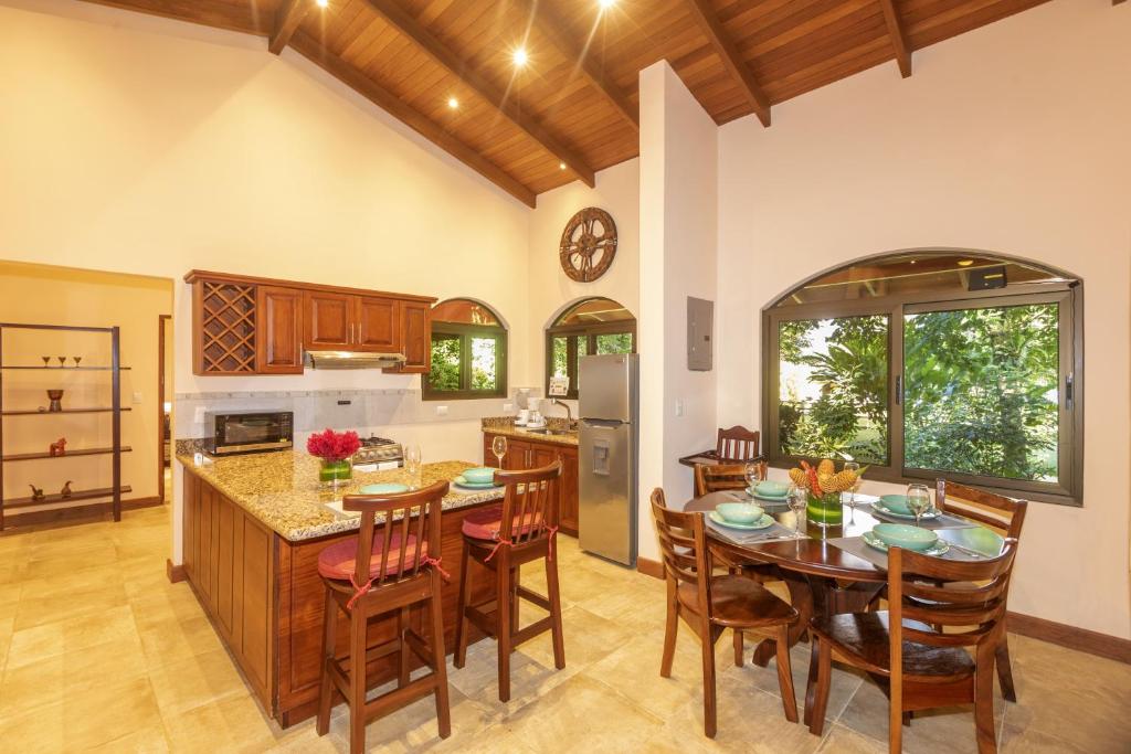 a kitchen and dining room with a table and chairs at Three Bedroom Two Bath Villa on 20 Acres of Nature! "Hana's Celeste Retreat" in Bijagua