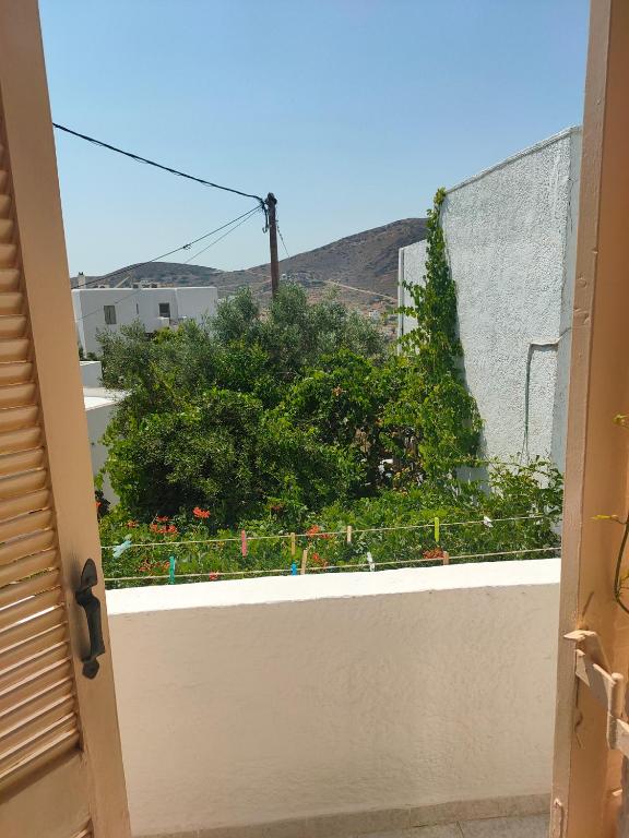 a window view of a garden from a balcony at Ios Penelope in Ios Chora