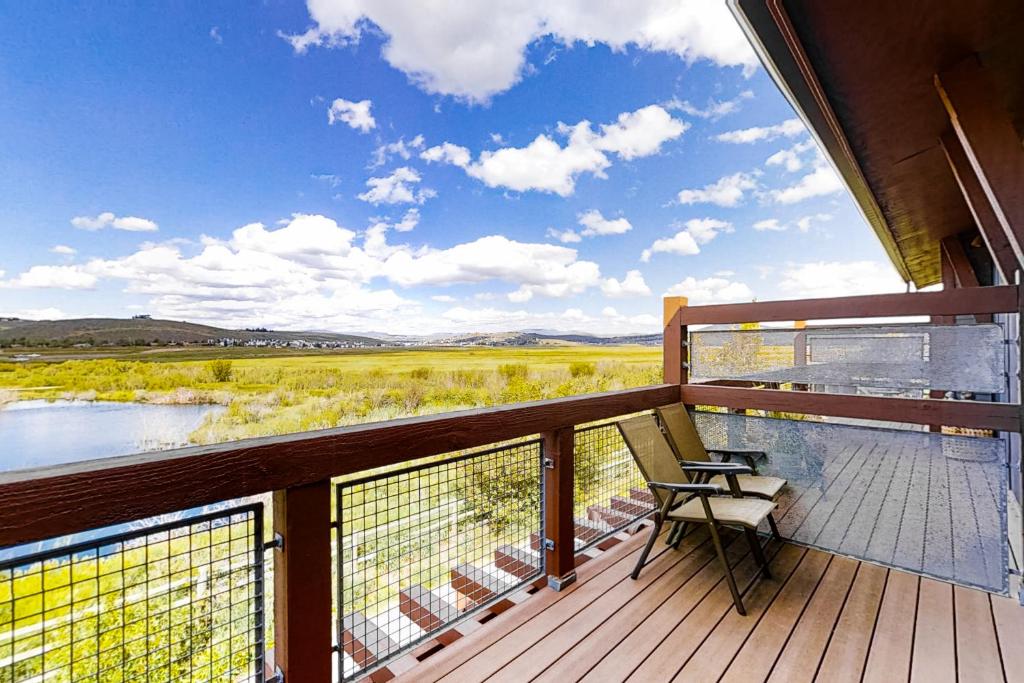a balcony with a bench and a view of a river at Newpark Townhomes 28 in Park City