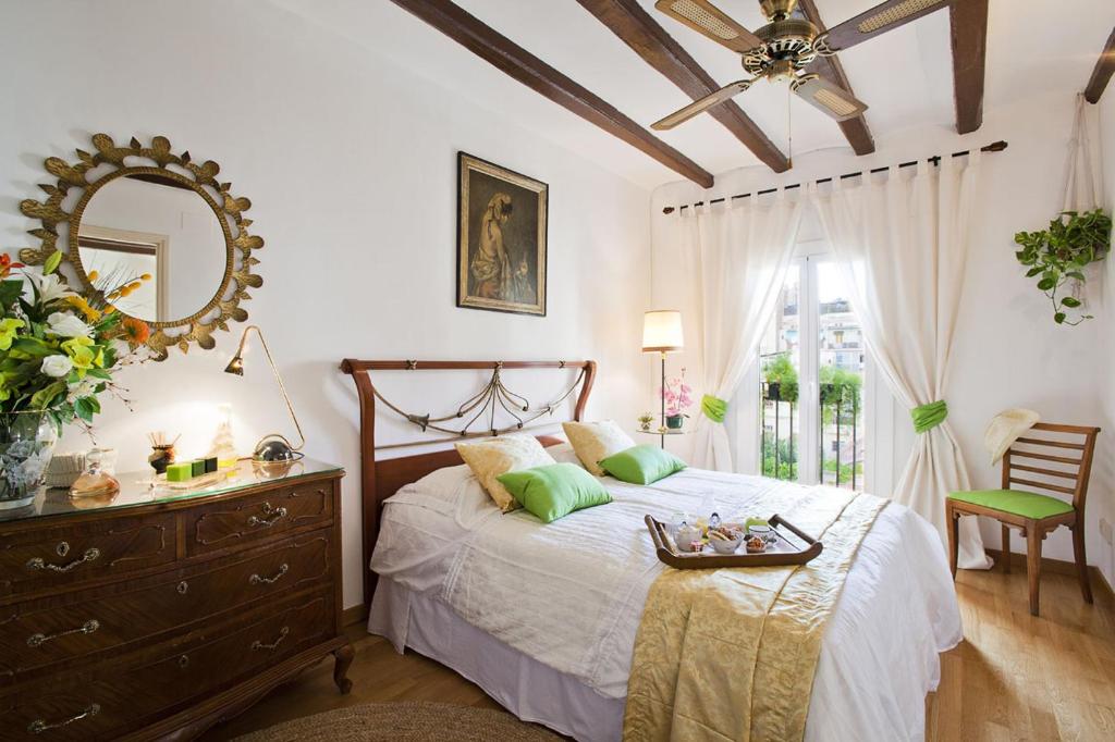 a bedroom with a bed with a dresser and a mirror at Apartment Eixample Comfort in Barcelona
