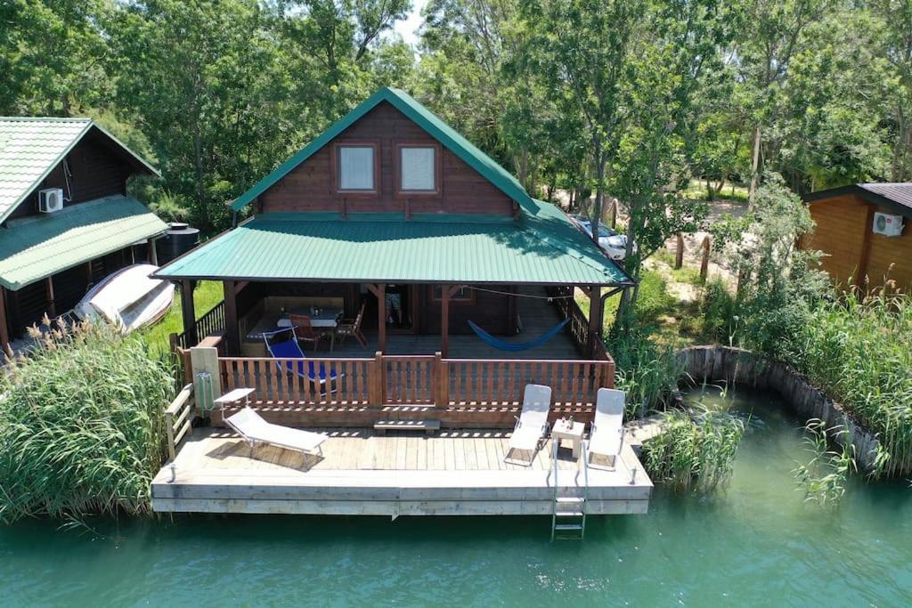 a house on a dock in the water at Filipa River House Ada Bojana in Ulcinj