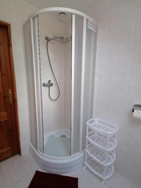 a shower with a glass door in a bathroom at Apartmány 670 pod Lysou horou in Rokytnice nad Jizerou