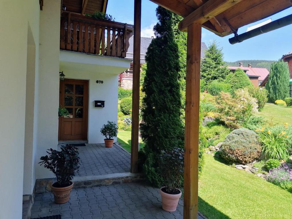 a view from the porch of a house with potted plants at Apartmány 670 pod Lysou horou in Rokytnice nad Jizerou