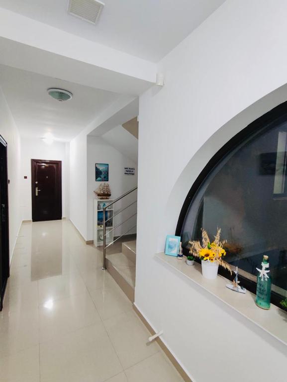 a hallway with a large window in a building at Vila Ardealul in Mangalia