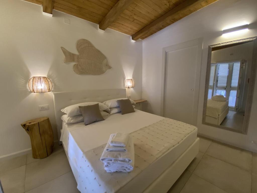a bedroom with a bed with a fish on the wall at Koralline accommodation in Tropea