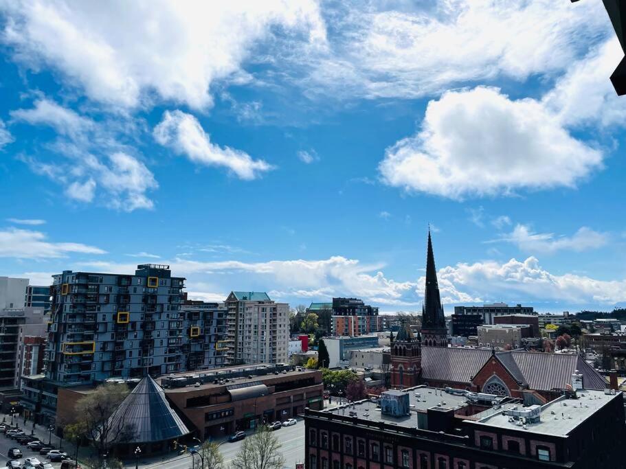 a view of a city with buildings and a blue sky at Lovely downtown 2 bedroom condo with free parking in Victoria