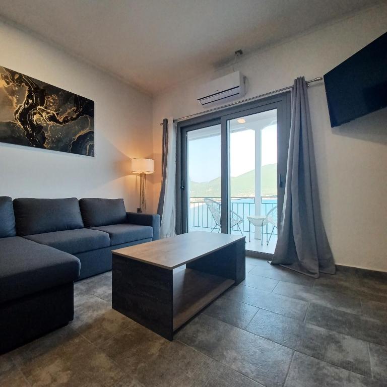 a living room with a couch and a coffee table at Ponti Bay Apartments in Vasiliki