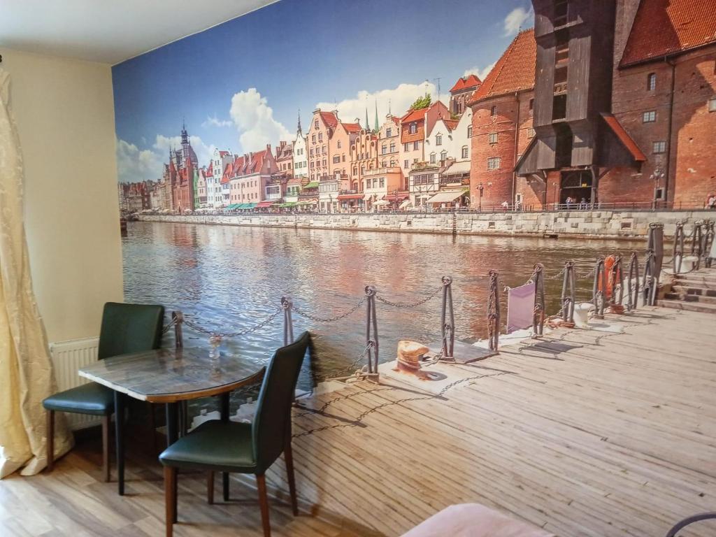 a dining room with a mural of a river at Gdansk CENTER I in Gdańsk