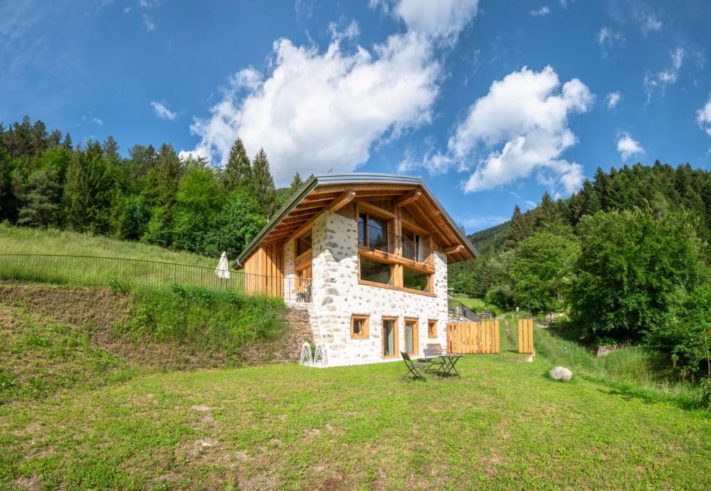 a log cabin in the middle of a field at Chalet Noèr in Ledro