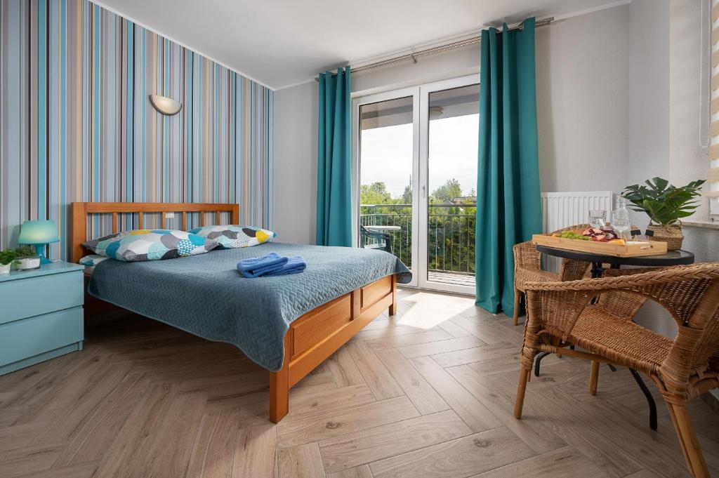 um quarto com uma cama, uma mesa e uma janela em Pasja Karwia em Karwia