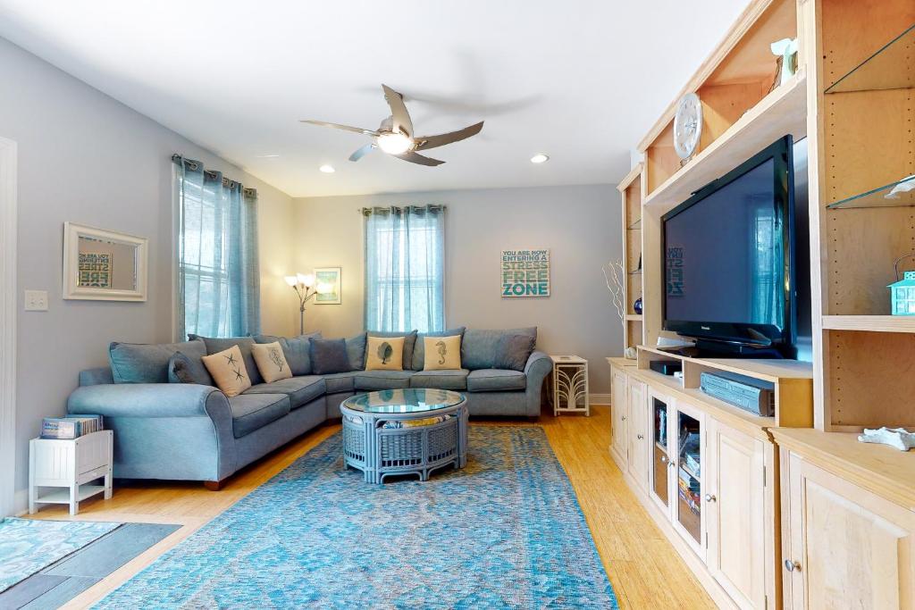 a living room with a couch and a flat screen tv at Town of Rehoboth Beach 109 Country Club Dr in Rehoboth Beach