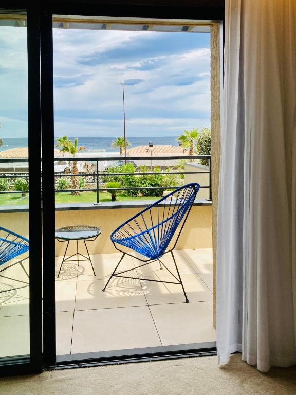 a view from a balcony with two chairs and a table at EDEN HÔTEL in Sainte-Maxime