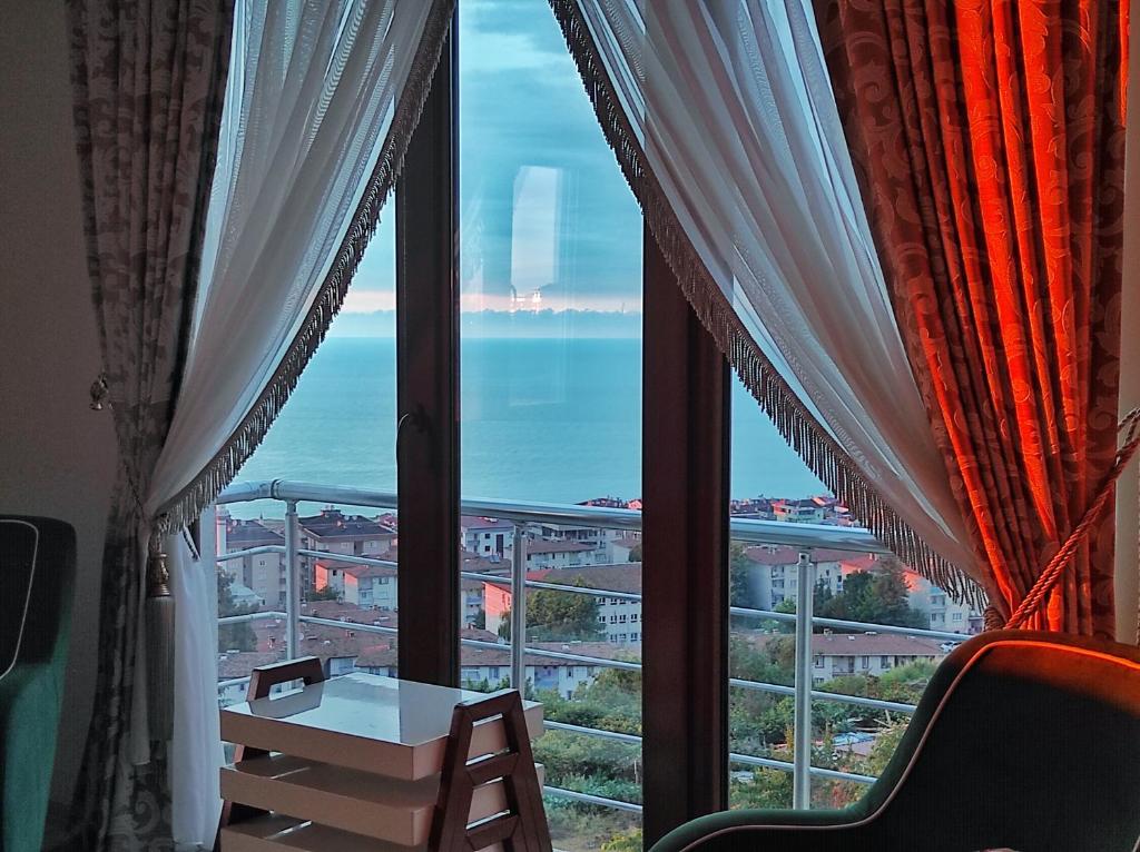 a view of the ocean from a hotel room window at Bahardali Suites - شقق غصن الربيع in Trabzon