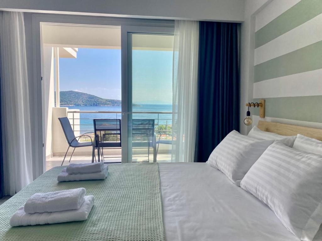 a bedroom with a bed with a view of the ocean at Elanthi in Skala Potamias