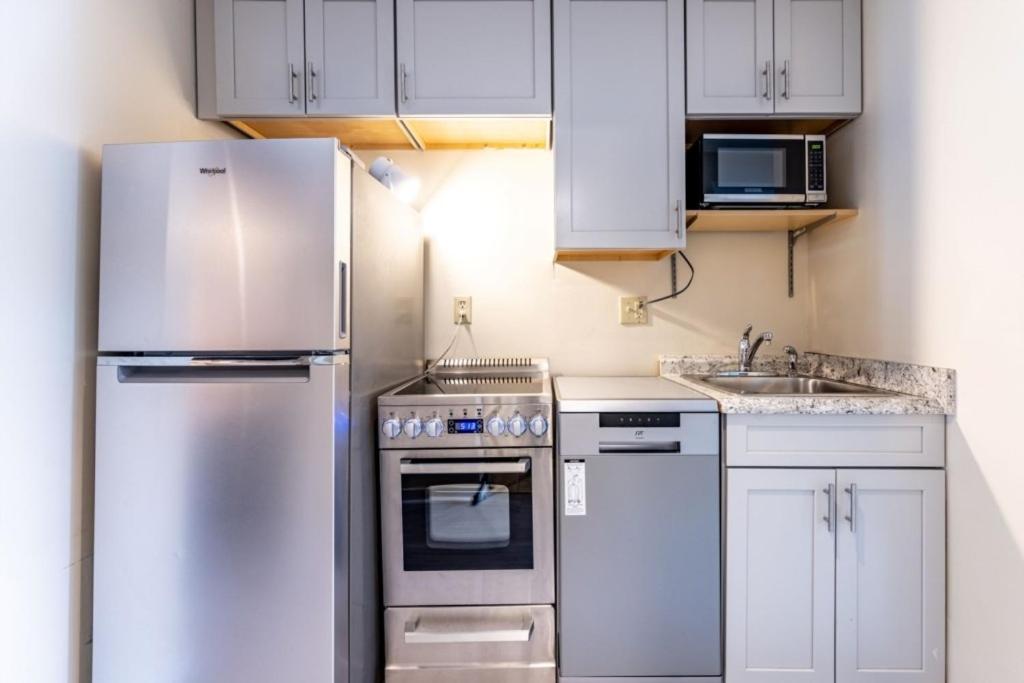a kitchen with white cabinets and a stainless steel refrigerator at TELEMARK 5 condo in Jeffersonville