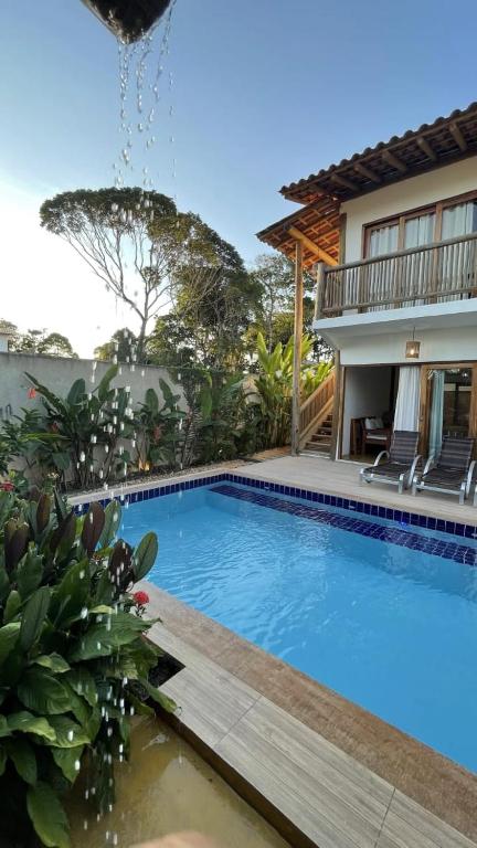 a swimming pool in front of a house at Casa Luar Trancoso in Trancoso