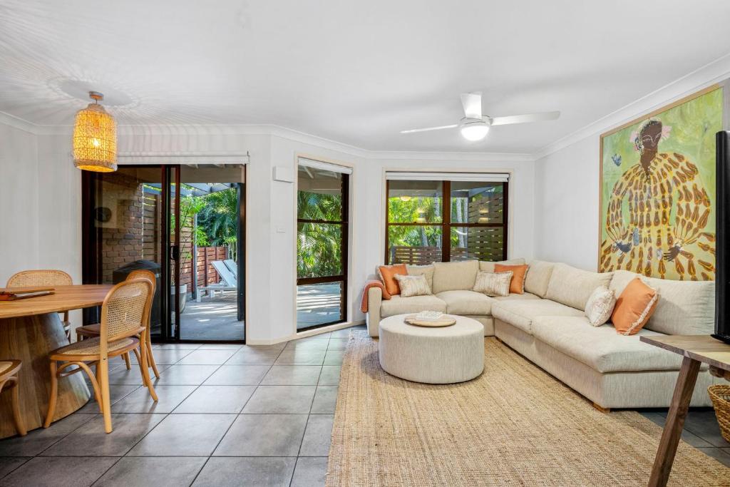 a living room with a couch and a table at Calinda Sol 11 in Byron Bay