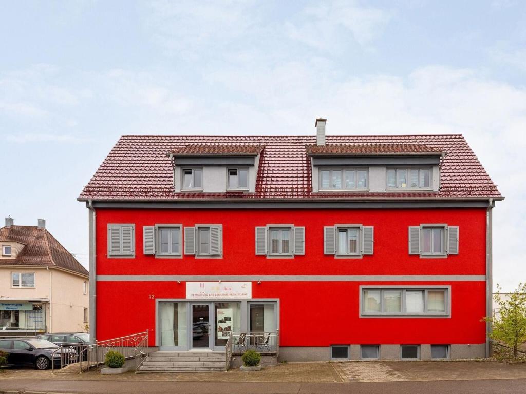 a red house with a red roof at Apartment only 100 m from Althausen Castle 