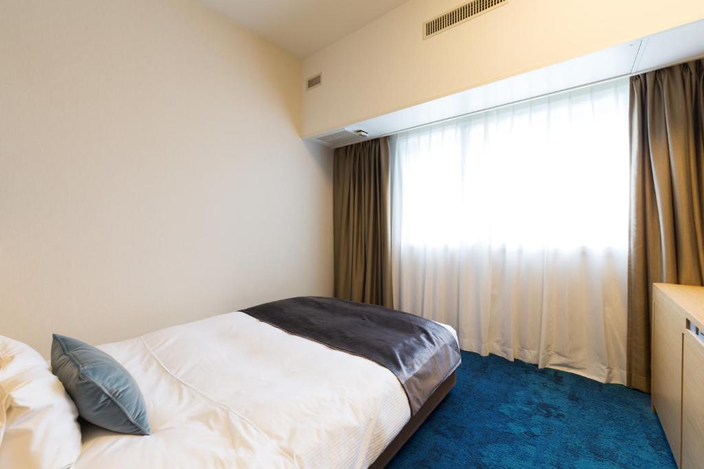 Postel nebo postele na pokoji v ubytování Art Hotel Narita