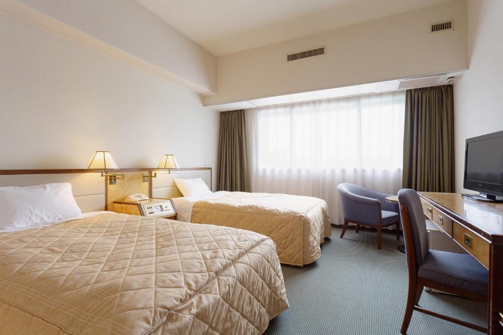 Postel nebo postele na pokoji v ubytování Art Hotel Narita