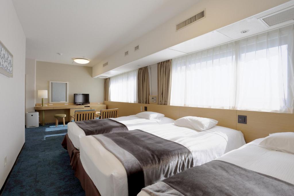 Postel nebo postele na pokoji v ubytování Art Hotel Narita