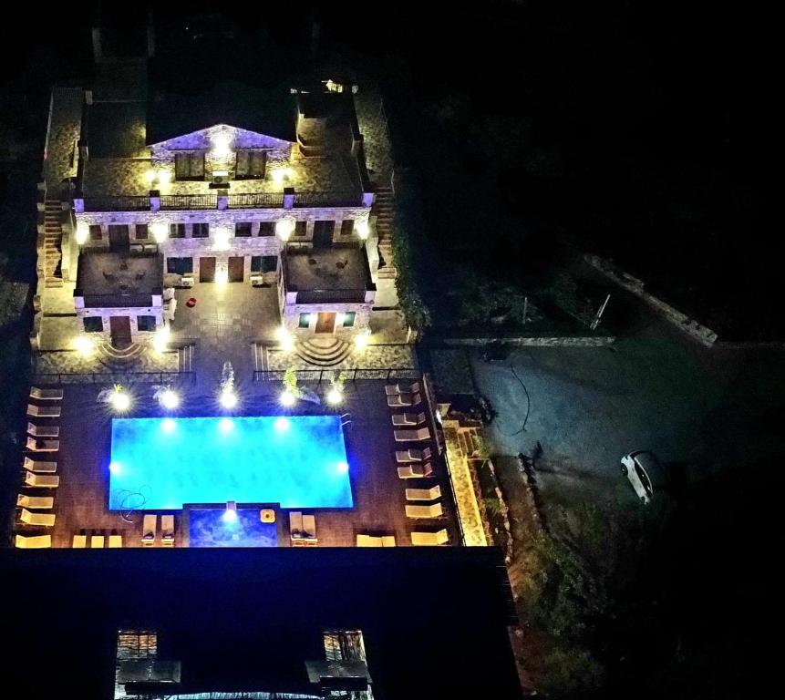 an overhead view of a swimming pool at night at Limni Resort in Ksamil