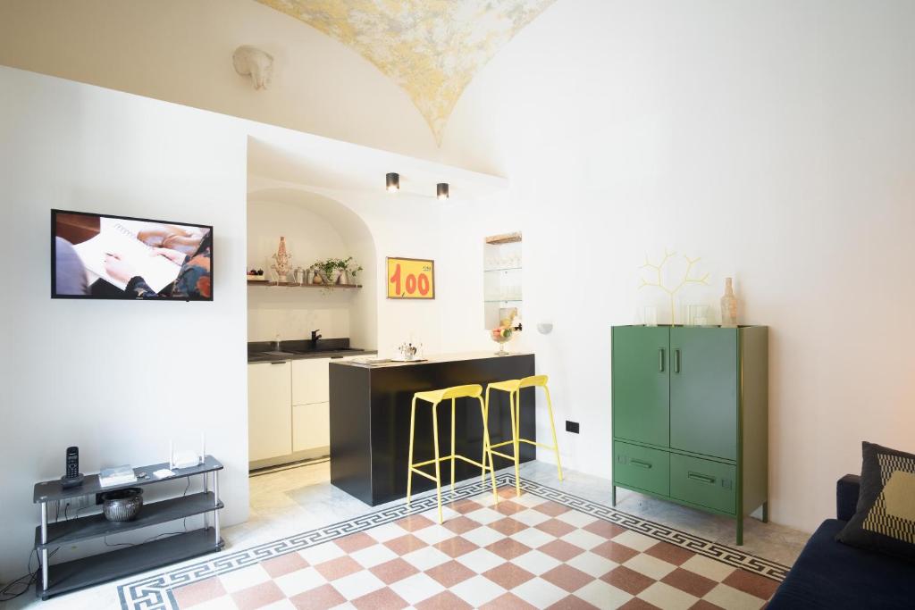 a living room with a green cabinet and a checkered floor at Casa Fauno by Dimorra in Naples