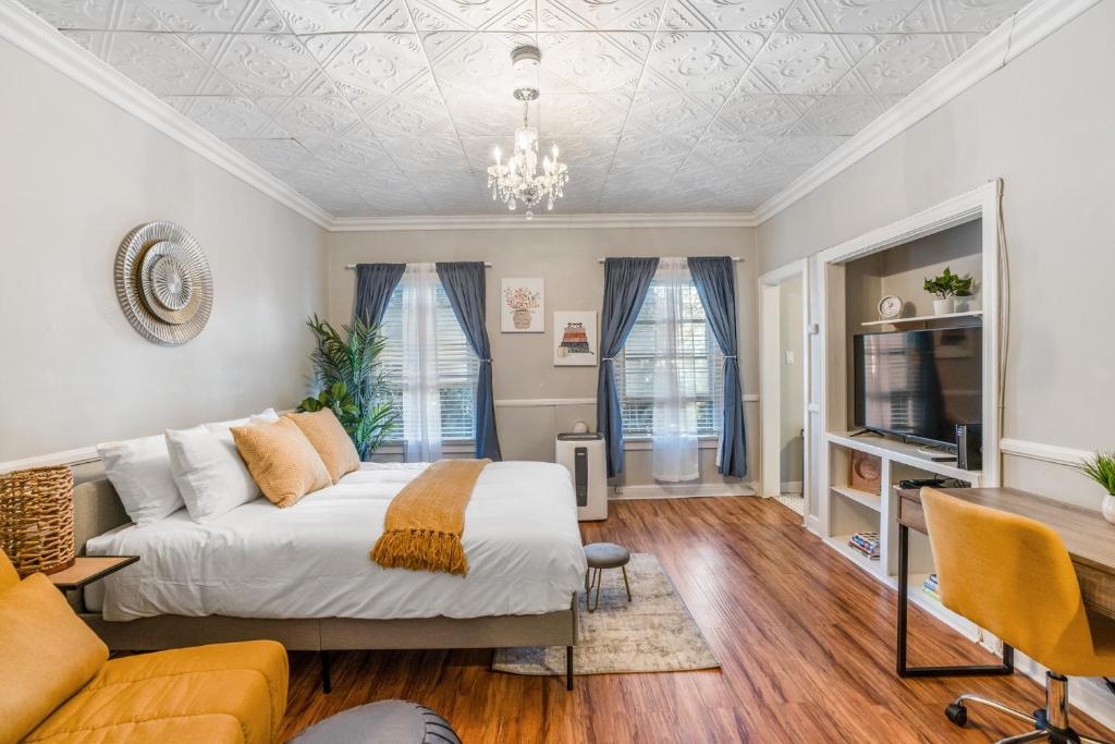 a bedroom with a bed and a couch and a tv at Your Charming Boho Abode in Los Angeles