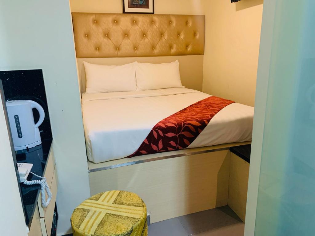 Postel nebo postele na pokoji v ubytování Sandpiper Hotel Singapore
