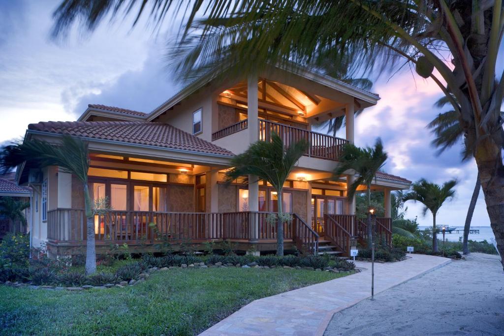 
a house that has a porch and some trees at Belizean Dreams Resort in Hopkins
