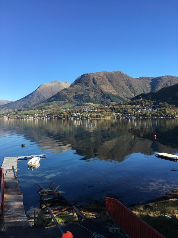 a view of a lake with mountains in the background at Fjord Apartments in Dimmelsvik
