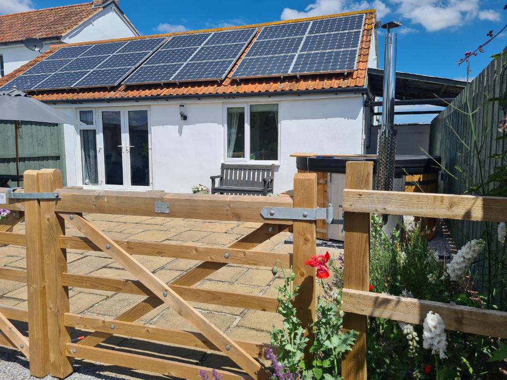 a house with solar panels on the roof at Thornhills Cottage in Bridgwater