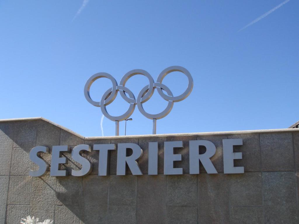 a sign for the olympics on top of a building at Hotel Lago Losetta in Sestriere