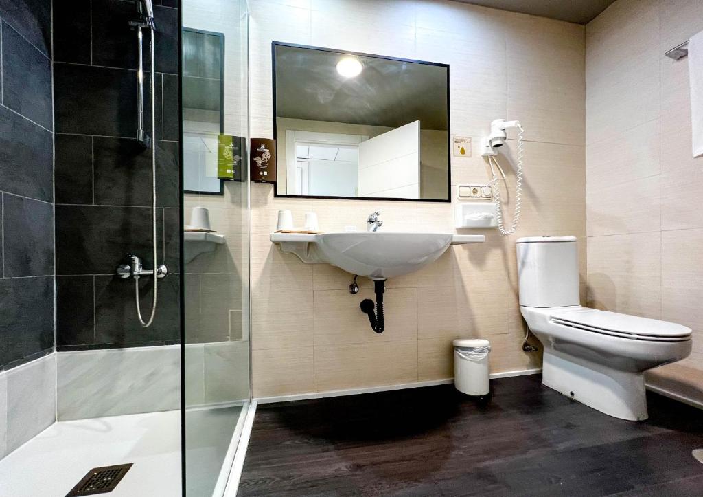 a bathroom with a sink and a toilet and a shower at Hotel MC San José in San José