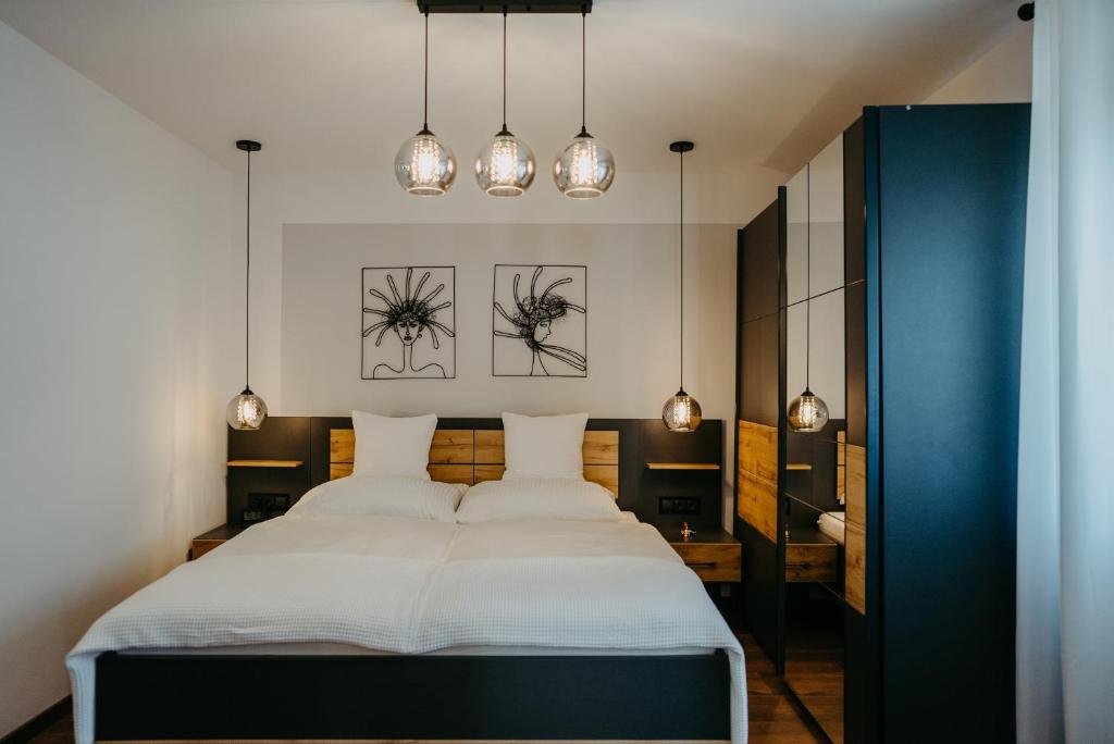 プルバッハ・アム・ノイジードラーゼーにあるFerienhaus25のベッドルーム1室(大型ベッド1台、照明2つ付)