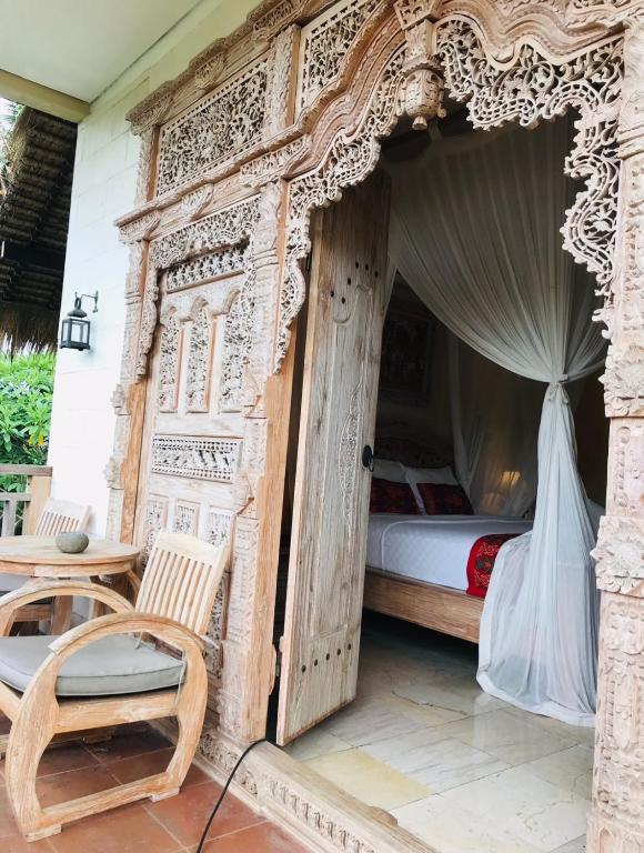 Postel nebo postele na pokoji v ubytování Kailash Bali