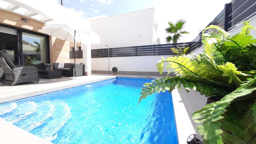 a swimming pool in the backyard of a house at Villa Wilhelmina in Torrevieja