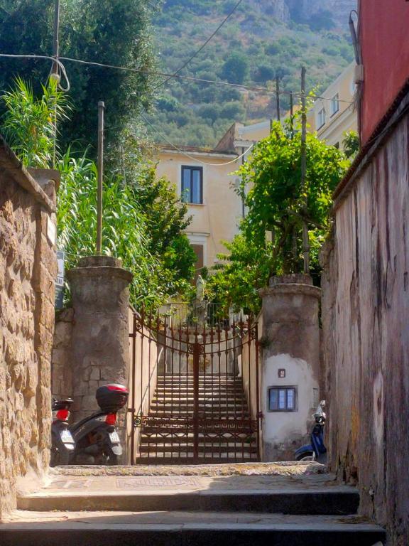 a stairway leading up to a house with a scooter at Coco's Apartment in Meta