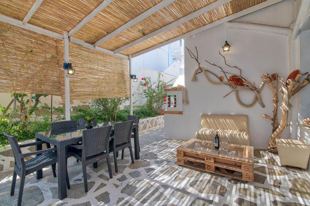a patio with a table and chairs and a bench at Hotel Antiparos in Antiparos Town